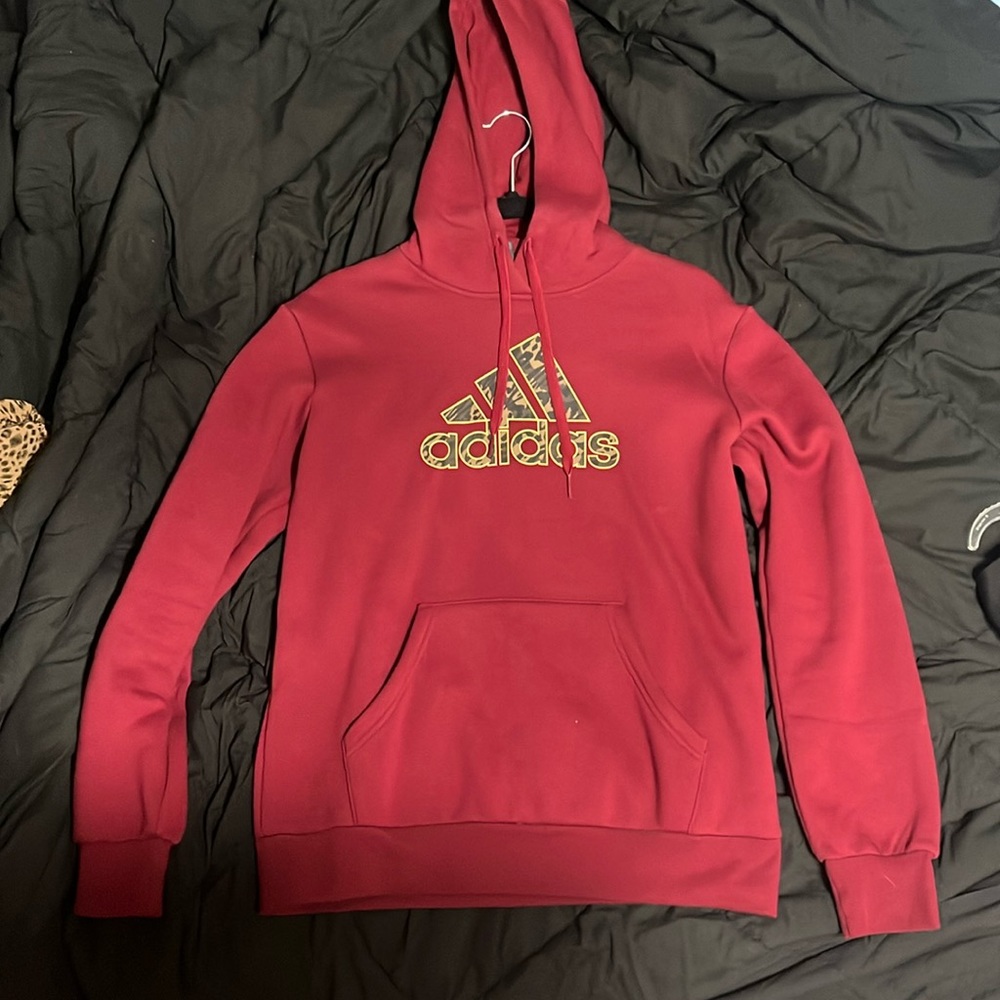 A garnet sweatshirt with a camo logo on it.